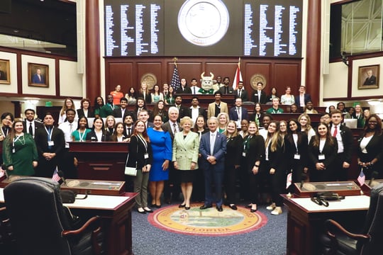 USF President Rhea Law poses with members of the USF community in the Chamber of the Florida House of Representatives