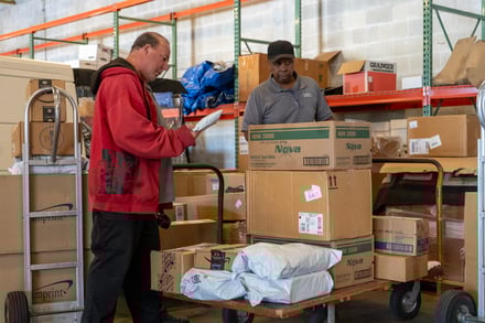 Employees sort packages for delivery.