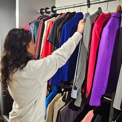 A student looks for professional attire on a clothing rack