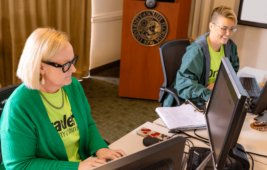 Team members work on computers