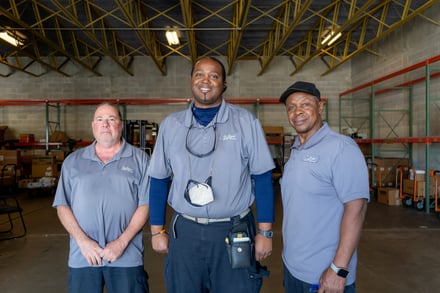 Central receiving team members pose for a photo.